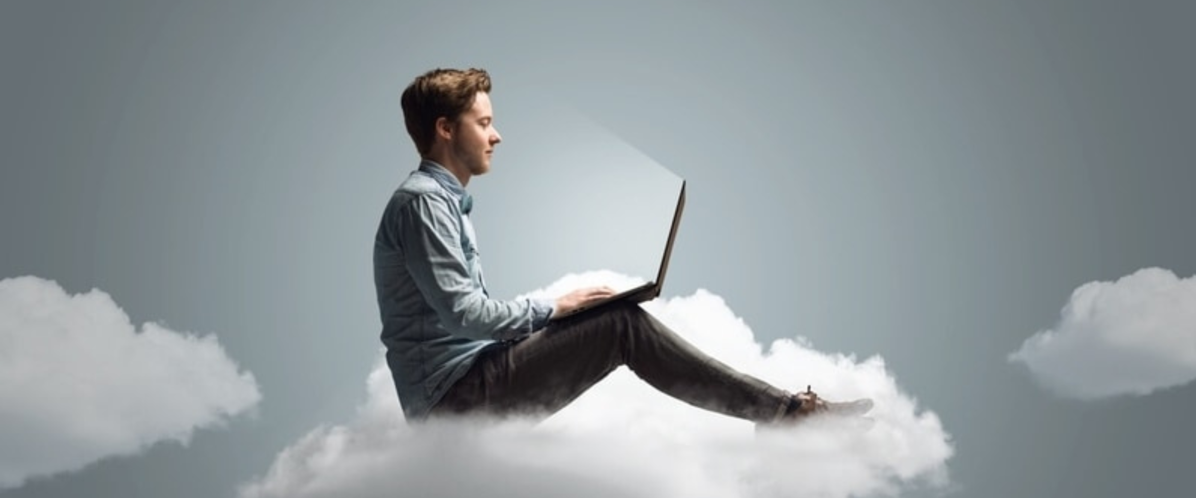 Man on cloud with laptop